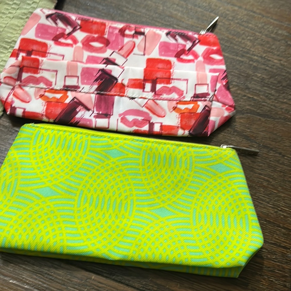New One red and pink Clinique cosmetic bagOne neon green Clinique cosmetic bag.